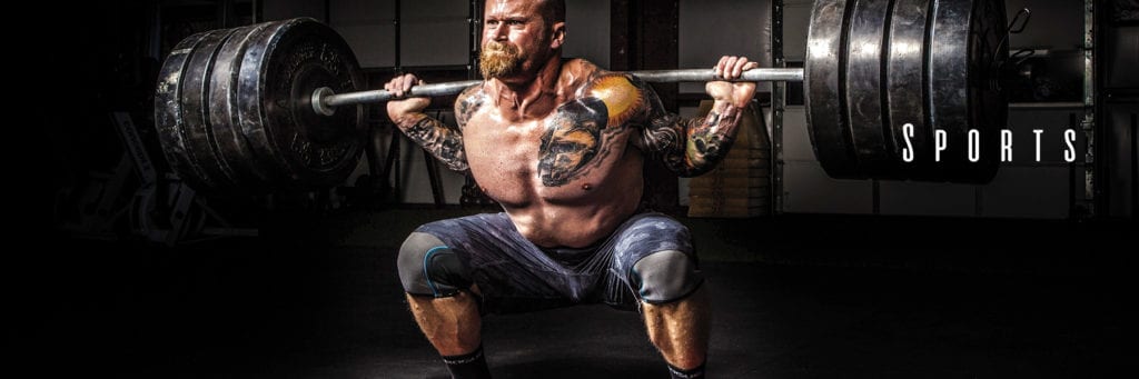 A man lifting weights in a gym.